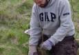 Sefton demonstrating immaculate tree planting technique